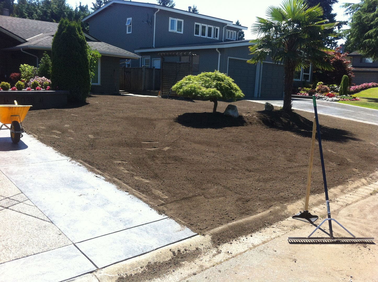 Freshly laid soil in a residential garden area.