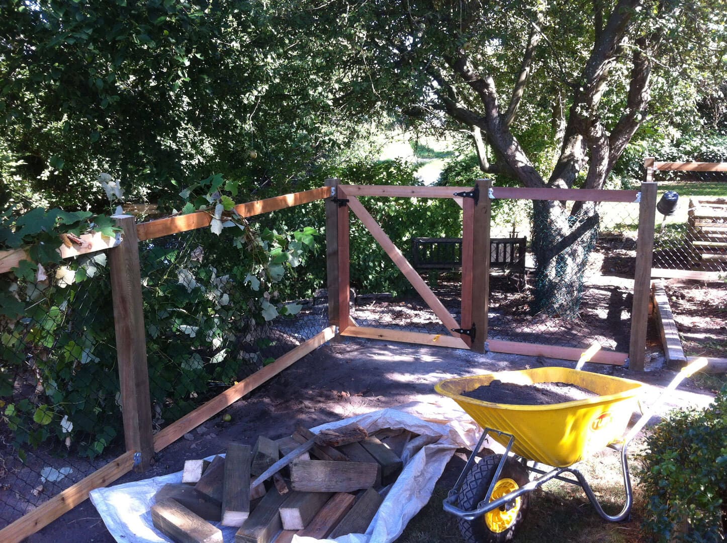 Wooden deck construction in progress with tools and materials scattered around.